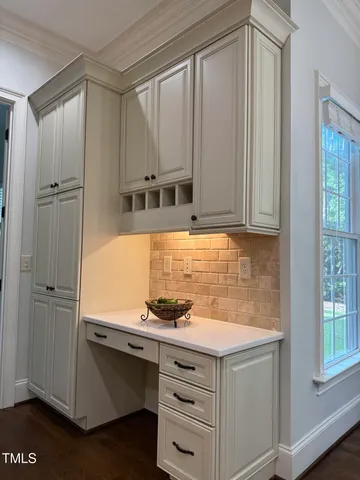a kitchen with stainless steel appliances cabinets and a window