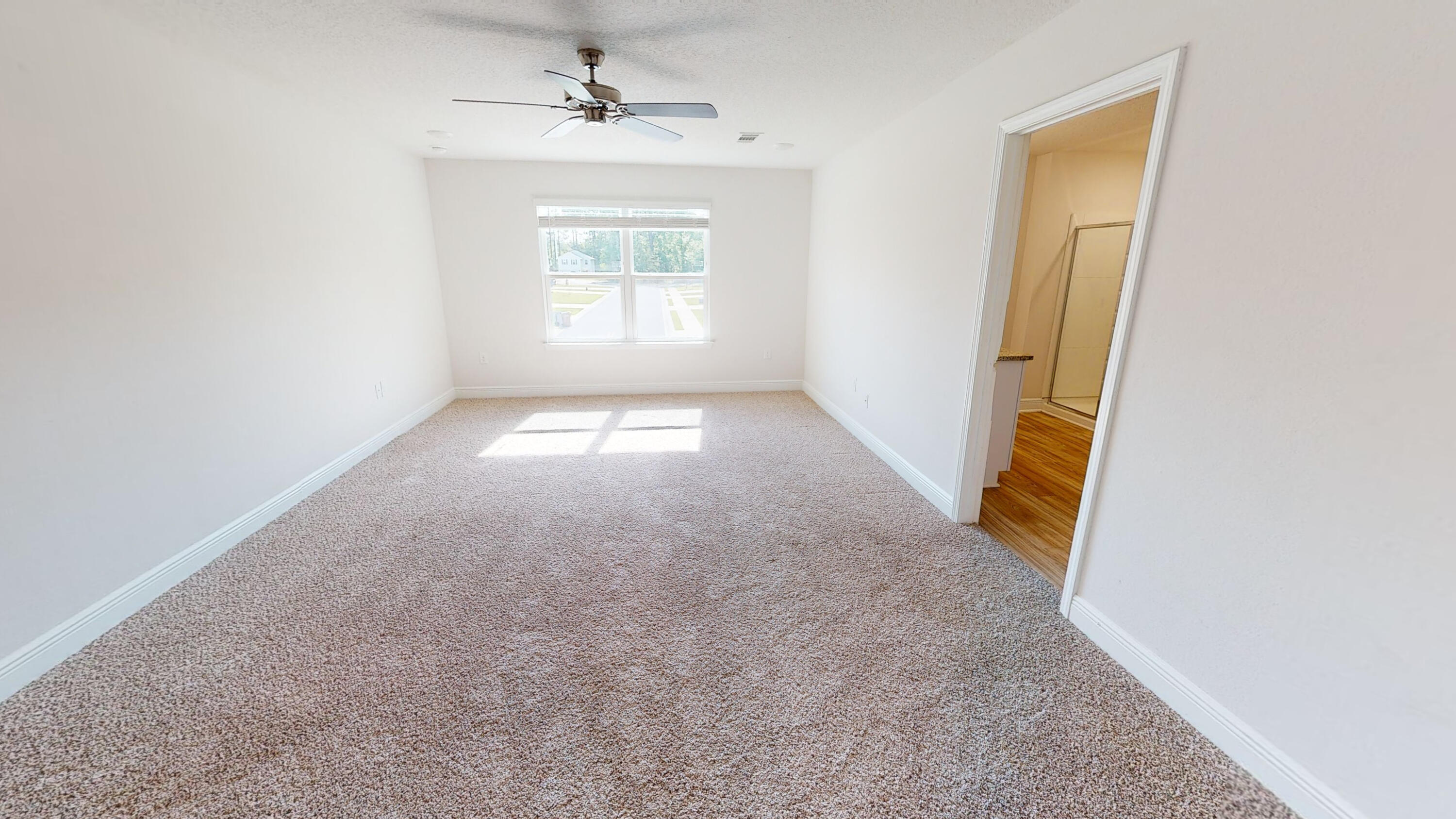 3139 Heritage Oaks Circle Navarre, FL 32566 - Photo 16 of 34 an empty room with windows and cabinet
