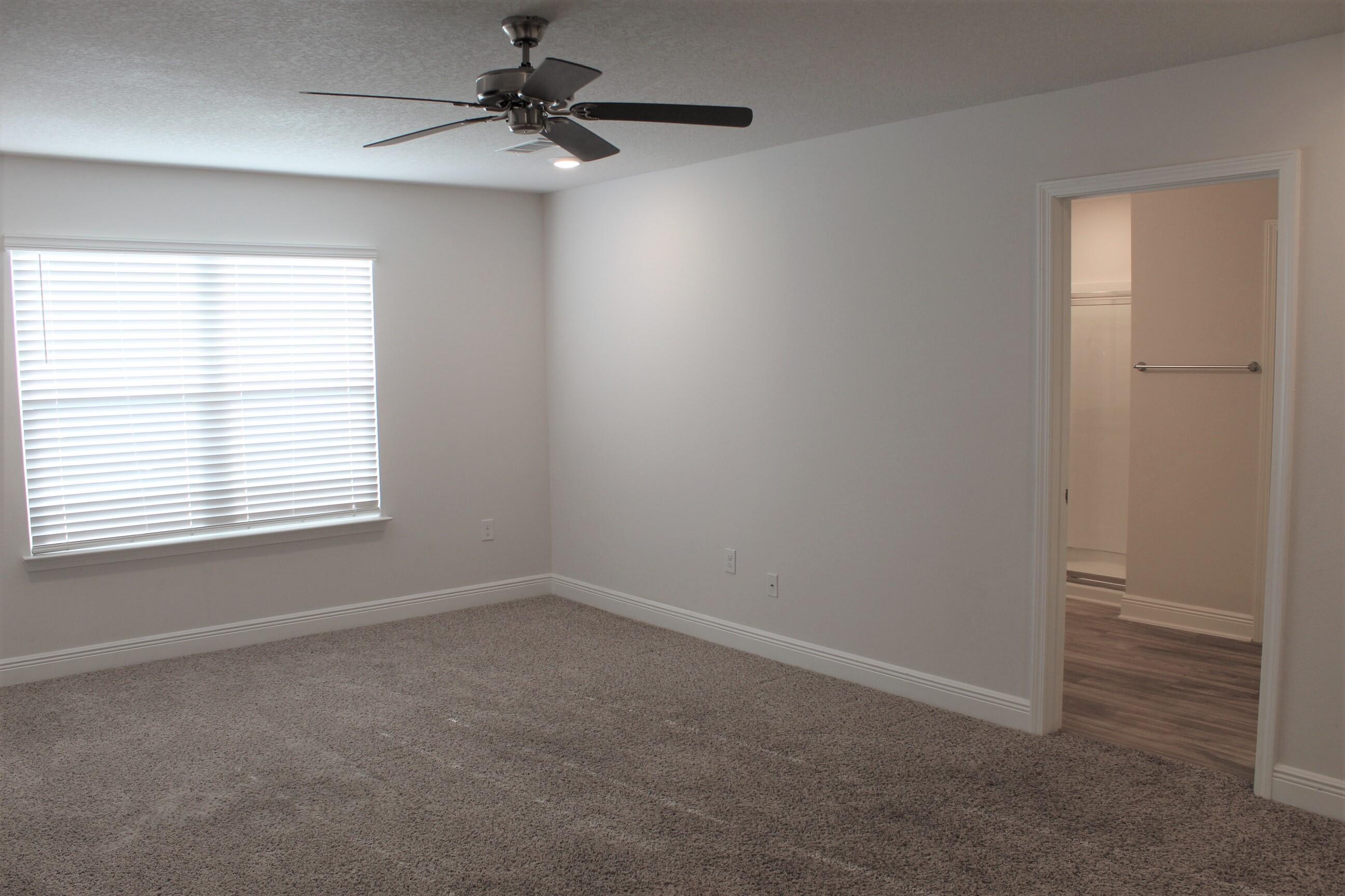 3139 Heritage Oaks Circle Navarre, FL 32566 - Photo 17 of 34 an empty room with a window and a fan