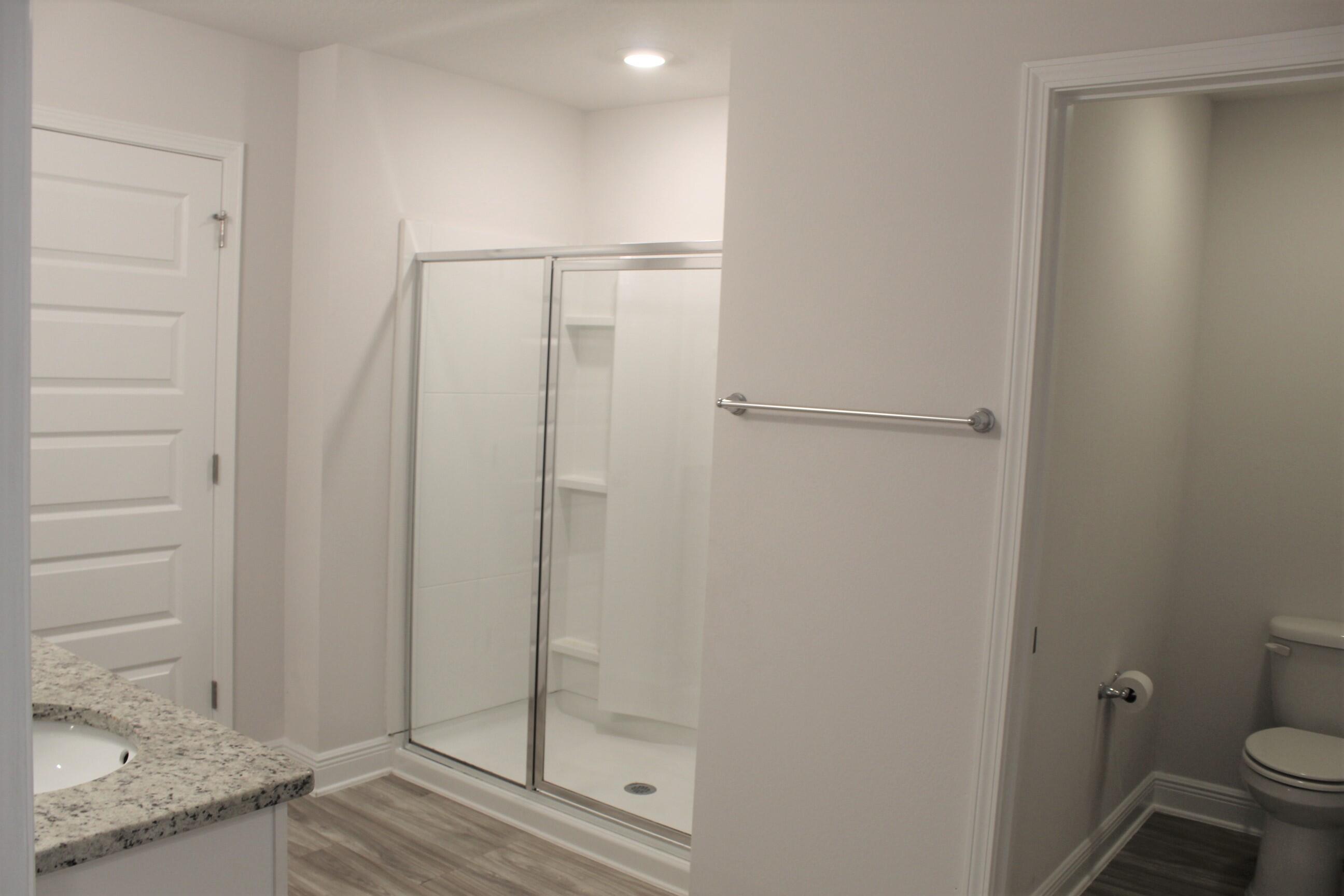 3139 Heritage Oaks Circle Navarre, FL 32566 - Photo 19 of 34 a bathroom with a shower and toilet