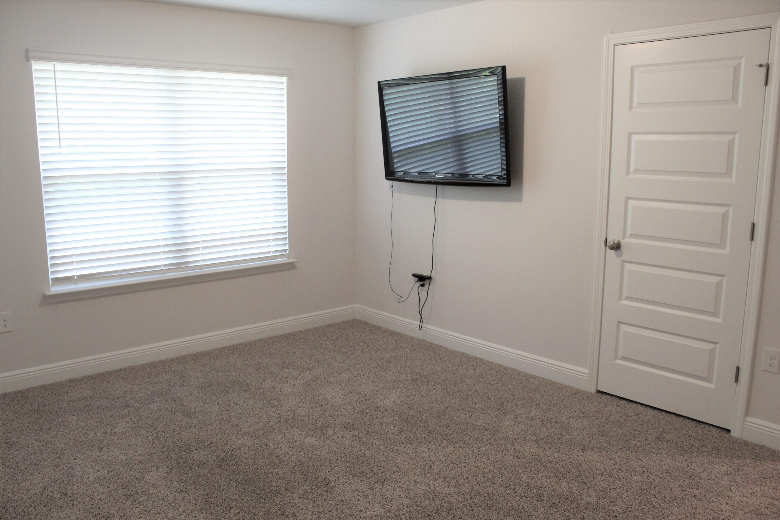 3139 Heritage Oaks Circle Navarre, FL 32566 - Photo 24 of 34 a view of an empty room with a window and a kitchen