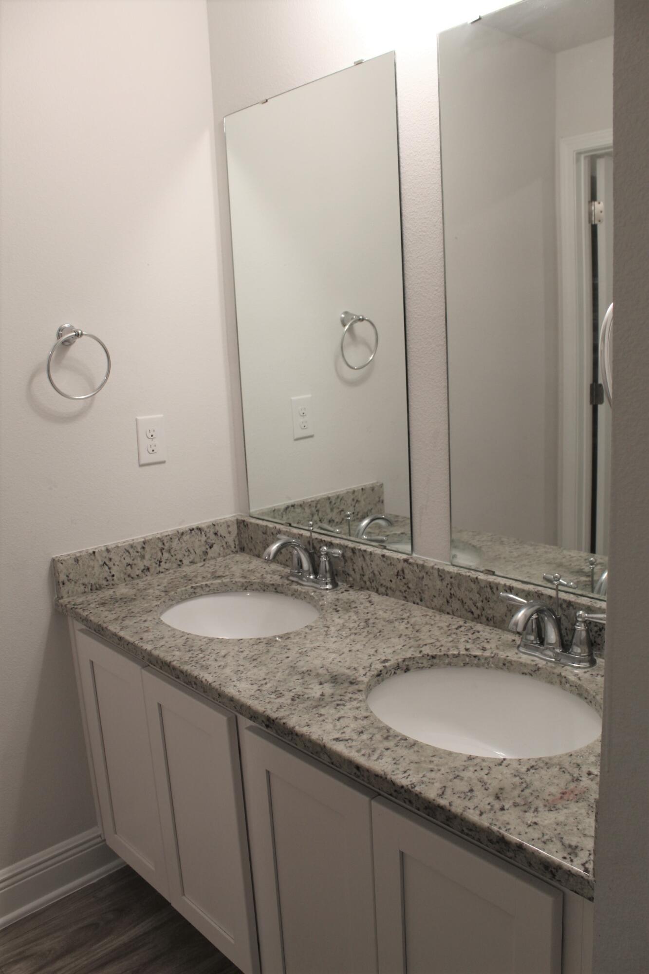 3139 Heritage Oaks Circle Navarre, FL 32566 - Photo 26 of 34 a bathroom with a granite countertop sink and a mirror