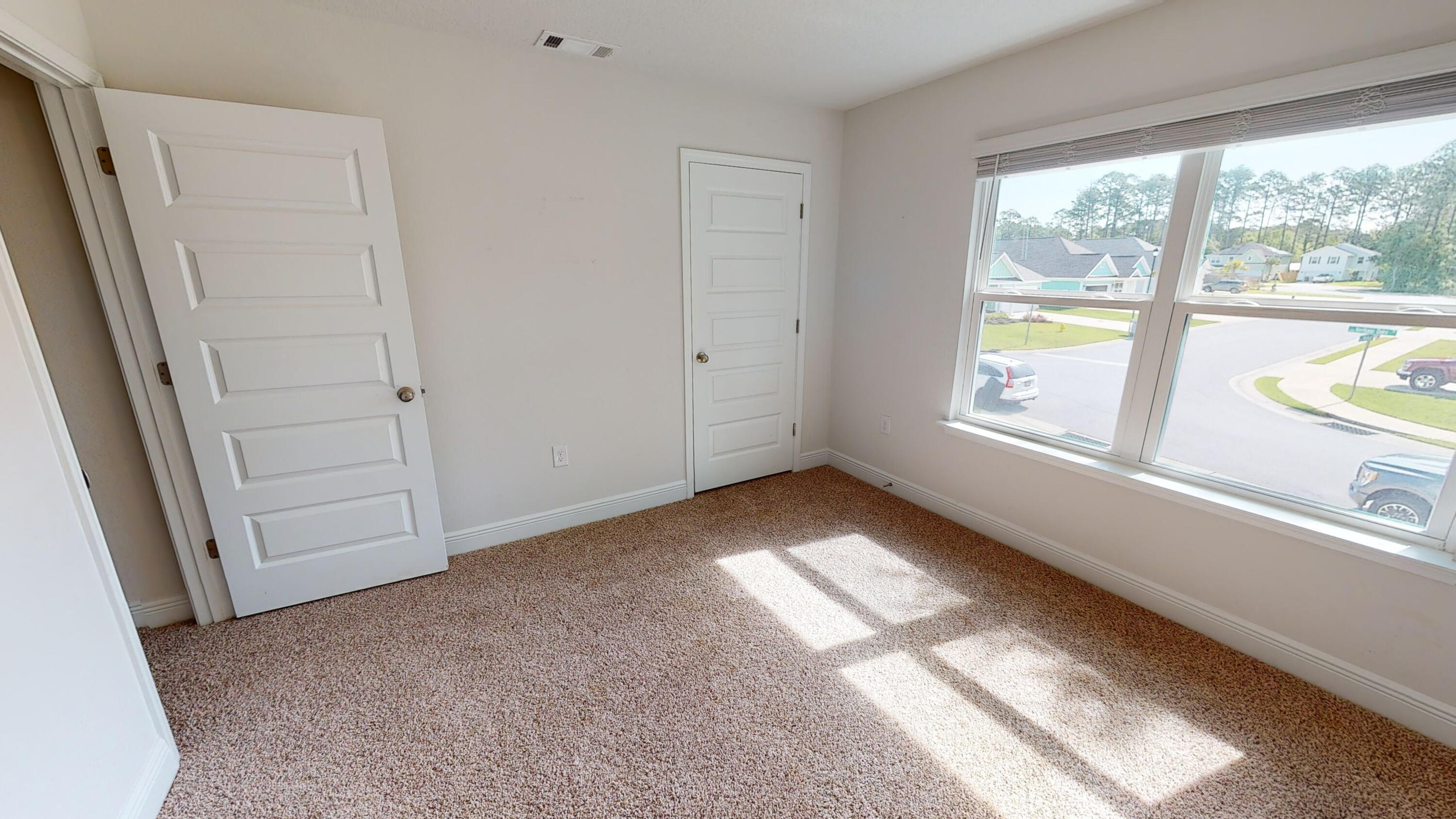 3139 Heritage Oaks Circle Navarre, FL 32566 - Photo 29 of 34 a view of empty room with floor to ceiling window