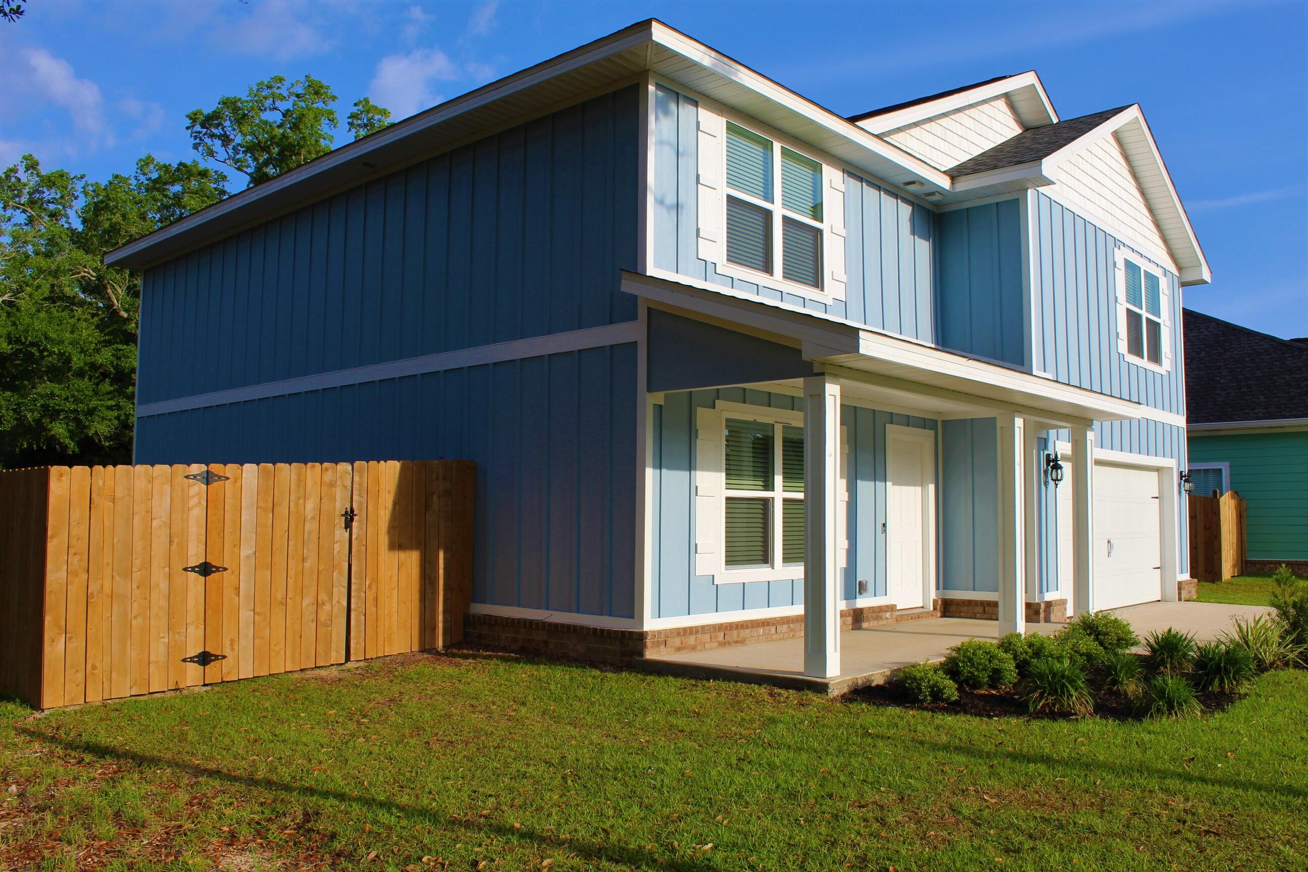 3139 Heritage Oaks Circle Navarre, FL 32566 - Photo 3 of 34 a front view of a house with a yard