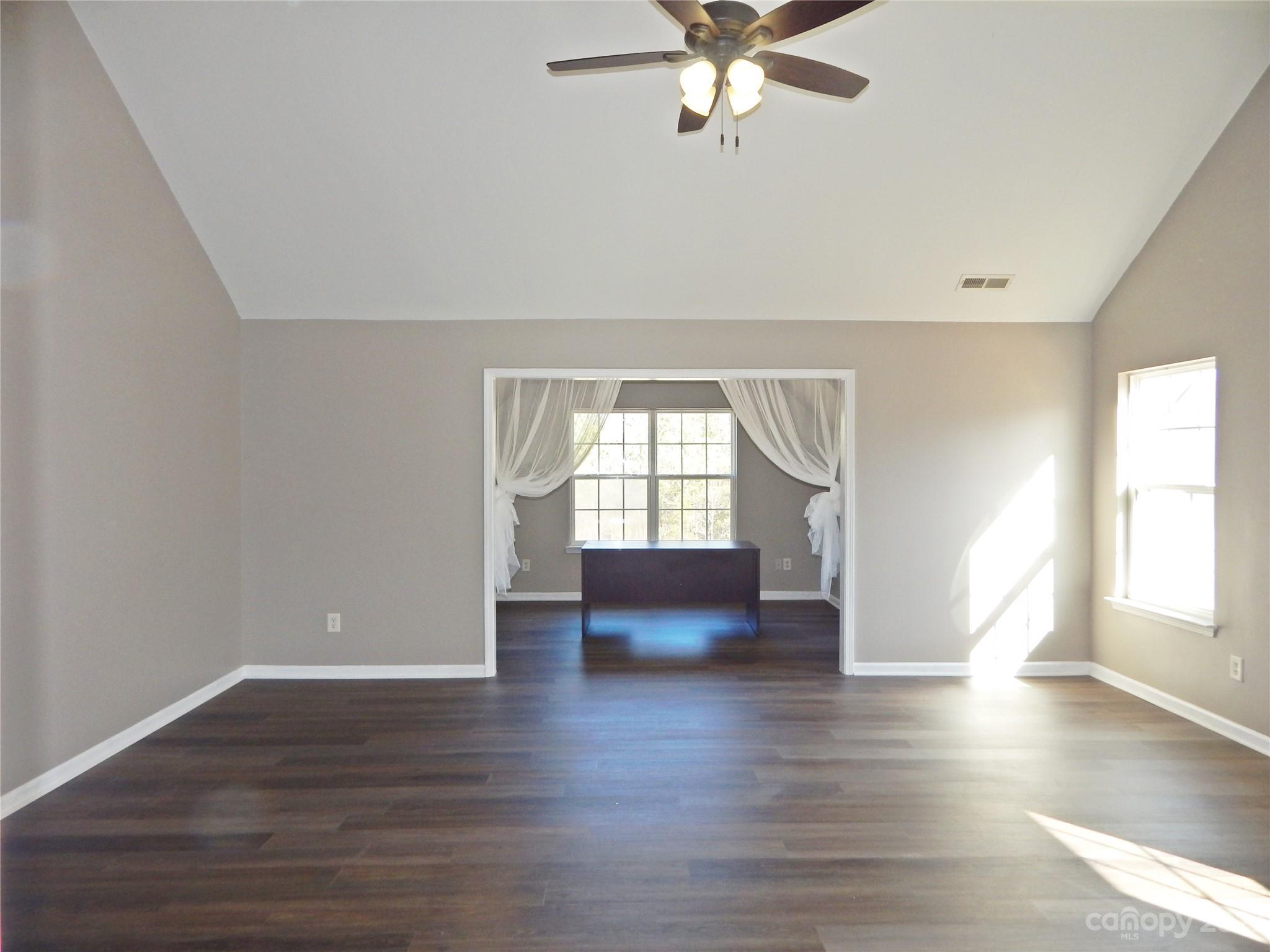 651 Fall Line Way Rock Hill, SC 29730 - Photo 17 of 25 an empty room with wooden floor and windows