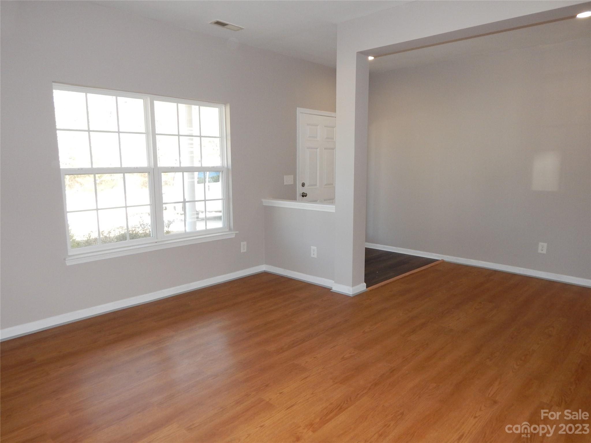 651 Fall Line Way Rock Hill, SC 29730 - Photo 5 of 25 an empty room with wooden floor and windows