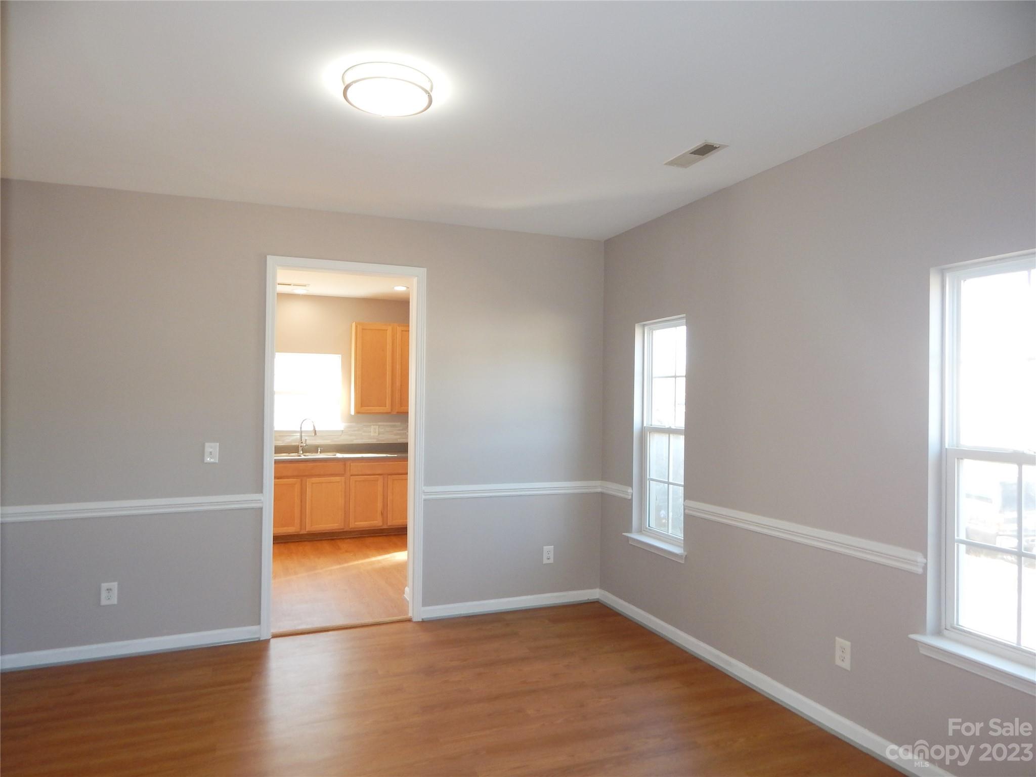 651 Fall Line Way Rock Hill, SC 29730 - Photo 6 of 25 an empty room with wooden floor and windows