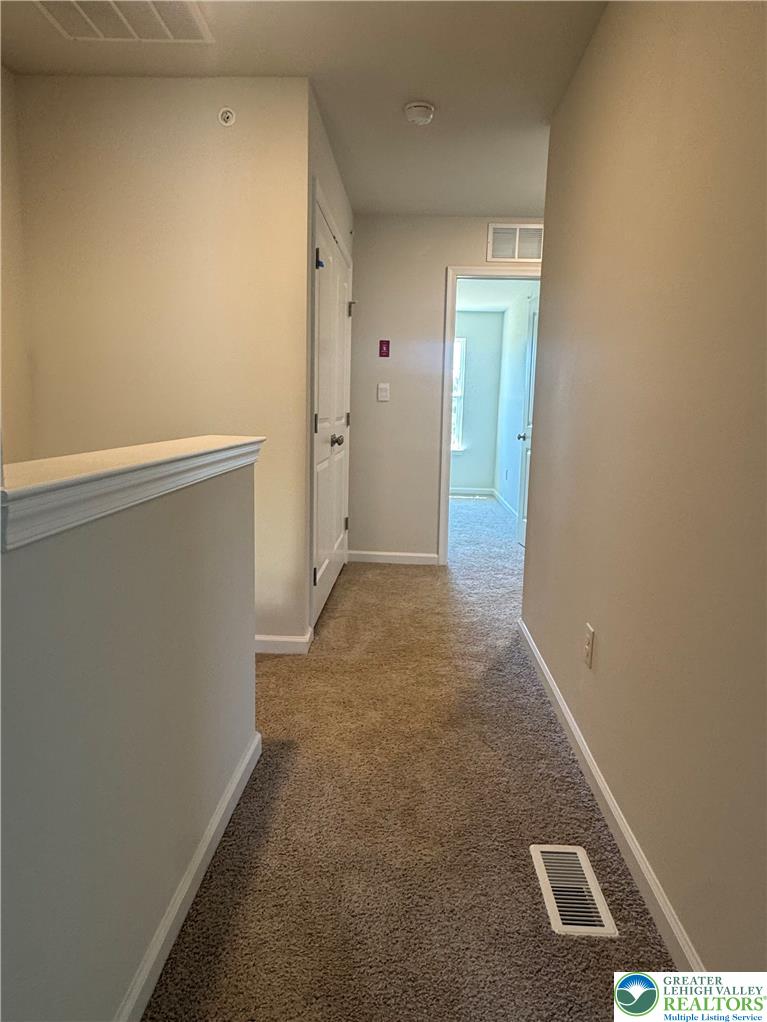 1168 Martin Road Breinigsville, PA 18031 - Photo 9 of 11 A well-lit hallway with plush carpeting provides clear access to adjoining rooms.