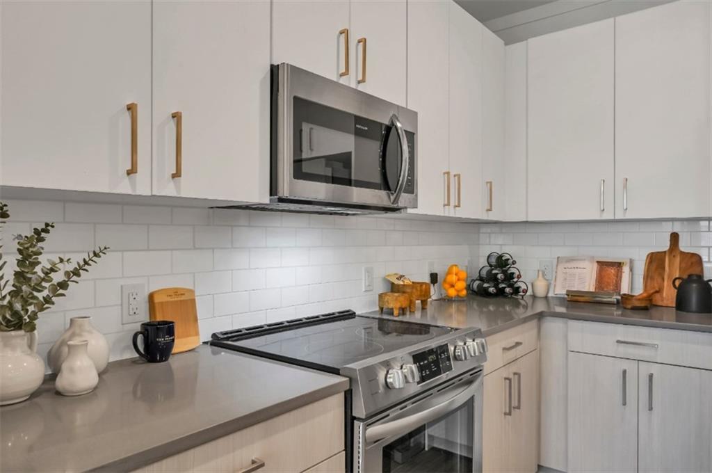 300 Prominence Point Parkway, Unit 1312 Canton, GA 30114 - Photo 2 of 25 a kitchen with a sink cabinets and appliances