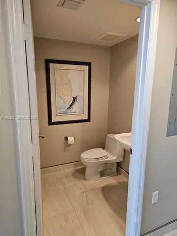 a bathroom with a toilet and a shower curtain