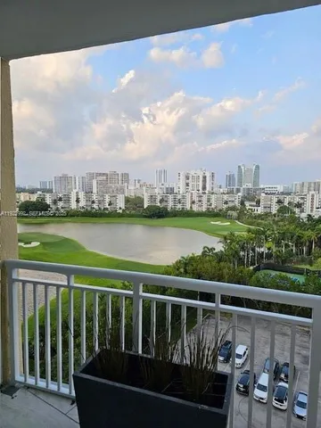 a view of a balcony with lake view and wooden floor