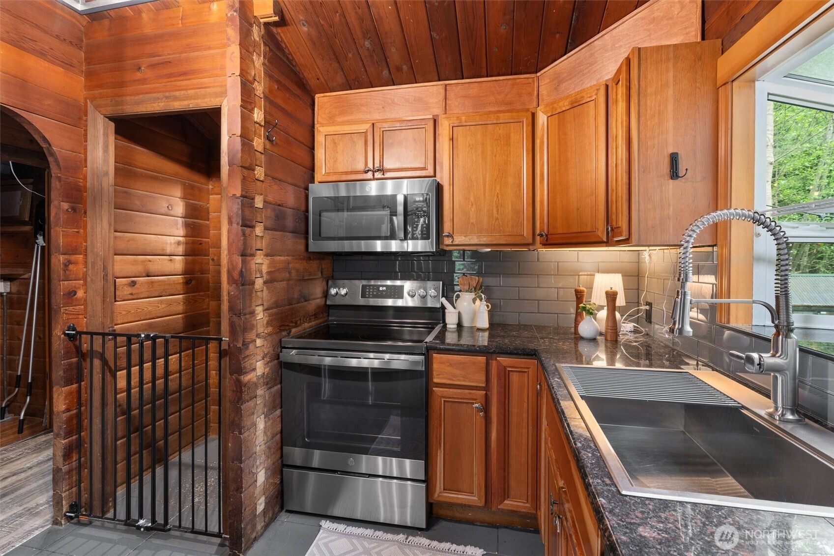 17629 Newberg Road Snohomish, WA 98290 - Photo 11 of 40 a kitchen with stainless steel appliances a stove a sink and a microwave
