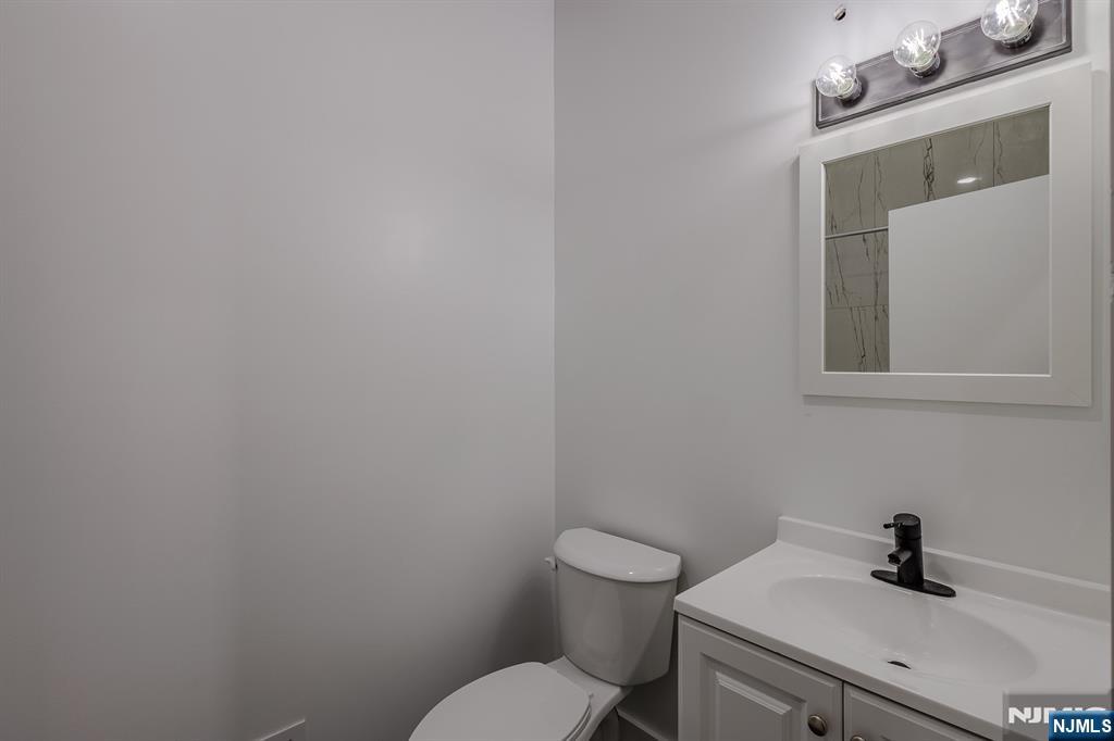 29 Kent Street Newark, NJ 07108 - Photo 14 of 30 a bathroom with a sink a toilet and mirror