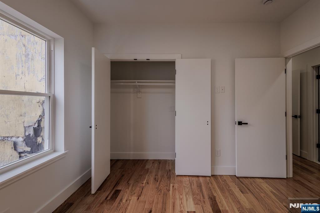 29 Kent Street Newark, NJ 07108 - Photo 17 of 30 a view of a hallway with wooden floor and closet