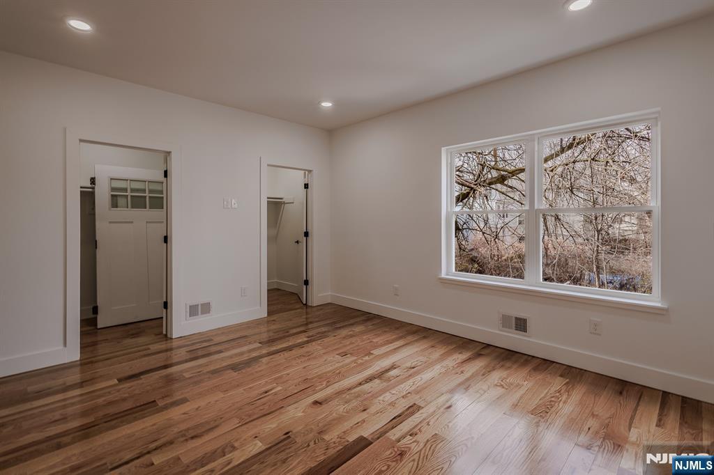 29 Kent Street Newark, NJ 07108 - Photo 18 of 30 a view of an empty room with wooden floor and a window