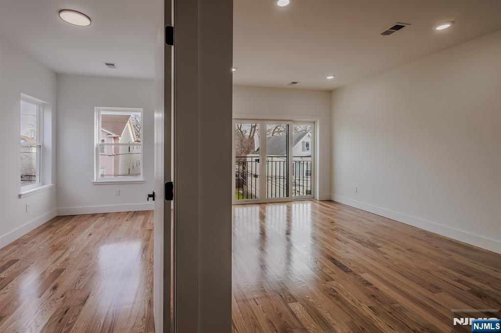 29 Kent Street Newark, NJ 07108 - Photo 24 of 30 wooden floor in an empty room with a window