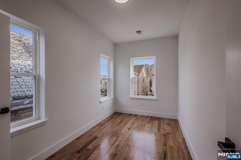 29 Kent Street Newark, NJ 07108 - Photo 25 of 30 a view of room with window and hardwood floor