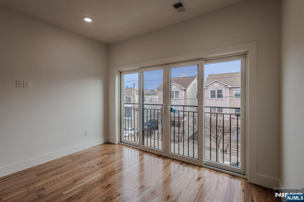29 Kent Street Newark, NJ 07108 - Photo 28 of 30 wooden floor in an empty room with a window