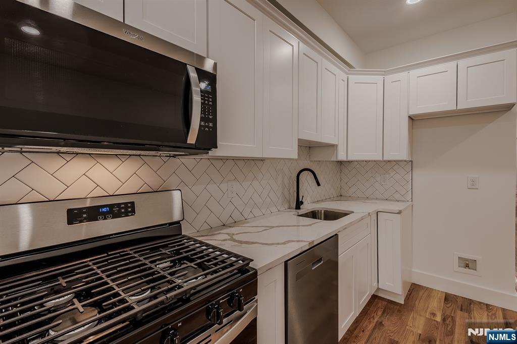 29 Kent Street Newark, NJ 07108 - Photo 4 of 30 a kitchen with a stove and a microwave