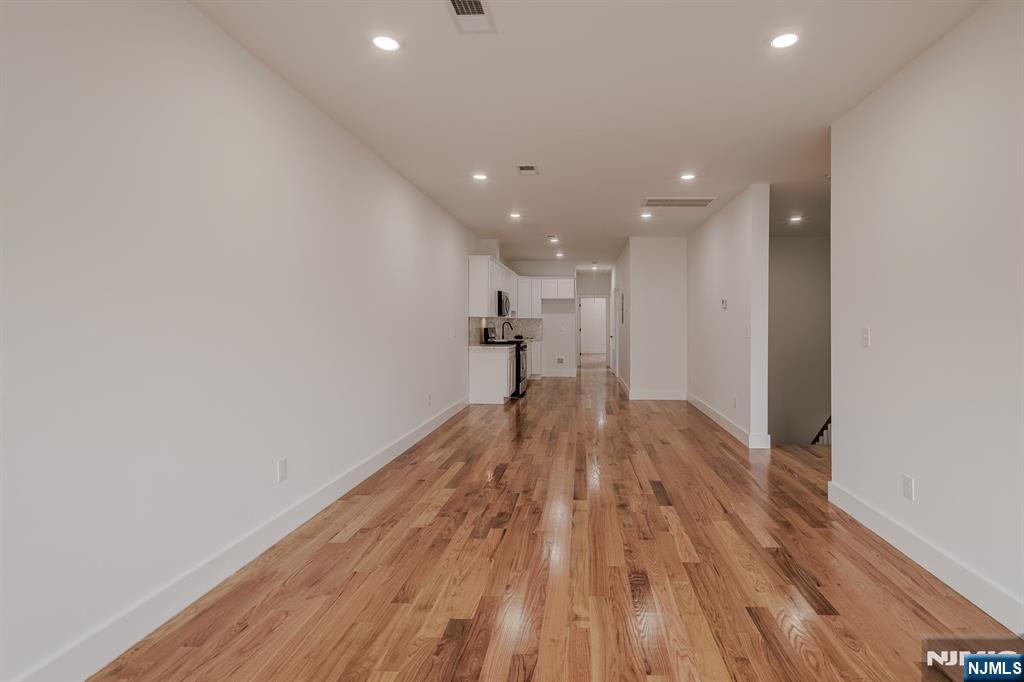 29 Kent Street Newark, NJ 07108 - Photo 9 of 30 a view of empty room with wooden floor