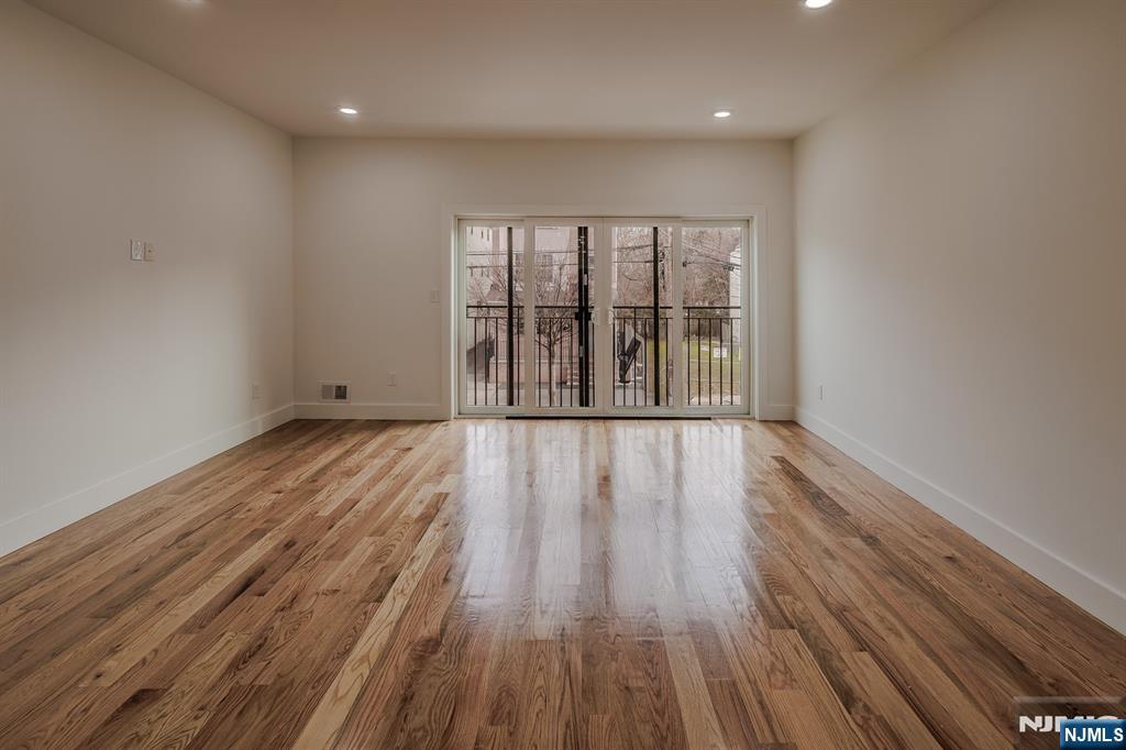 29 Kent Street Newark, NJ 07108 - Photo 10 of 30 wooden floor in an empty room with a window