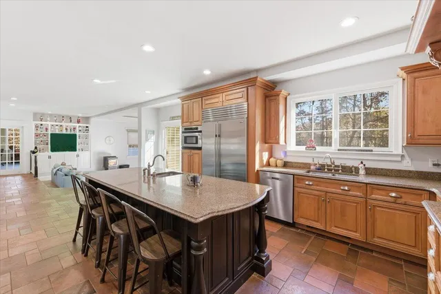a bedroom with a bed and a flat tv screen on dresser