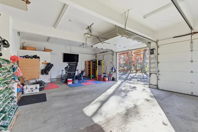 a view of a dining room with furniture a chandelier and wooden floor