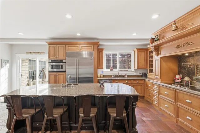 a spacious bathroom with a granite countertop sink mirror and toilet