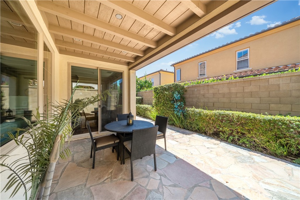 75 Gardenstone Path Irvine, CA 92620 - Photo 64 of 65 a porch with a table and chairs and potted plants