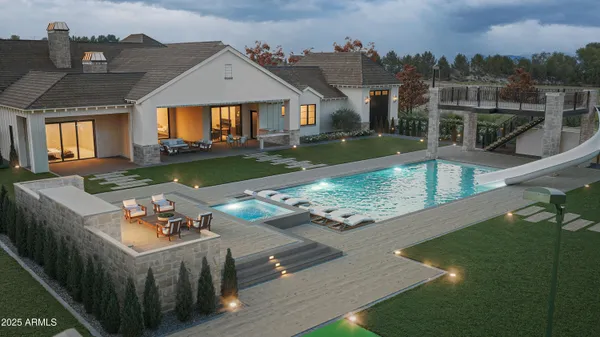 a view of a house with backyard and sitting area