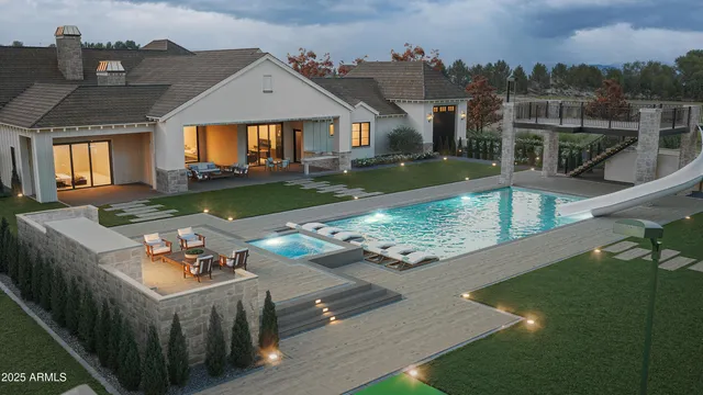 a view of a house with backyard and sitting area