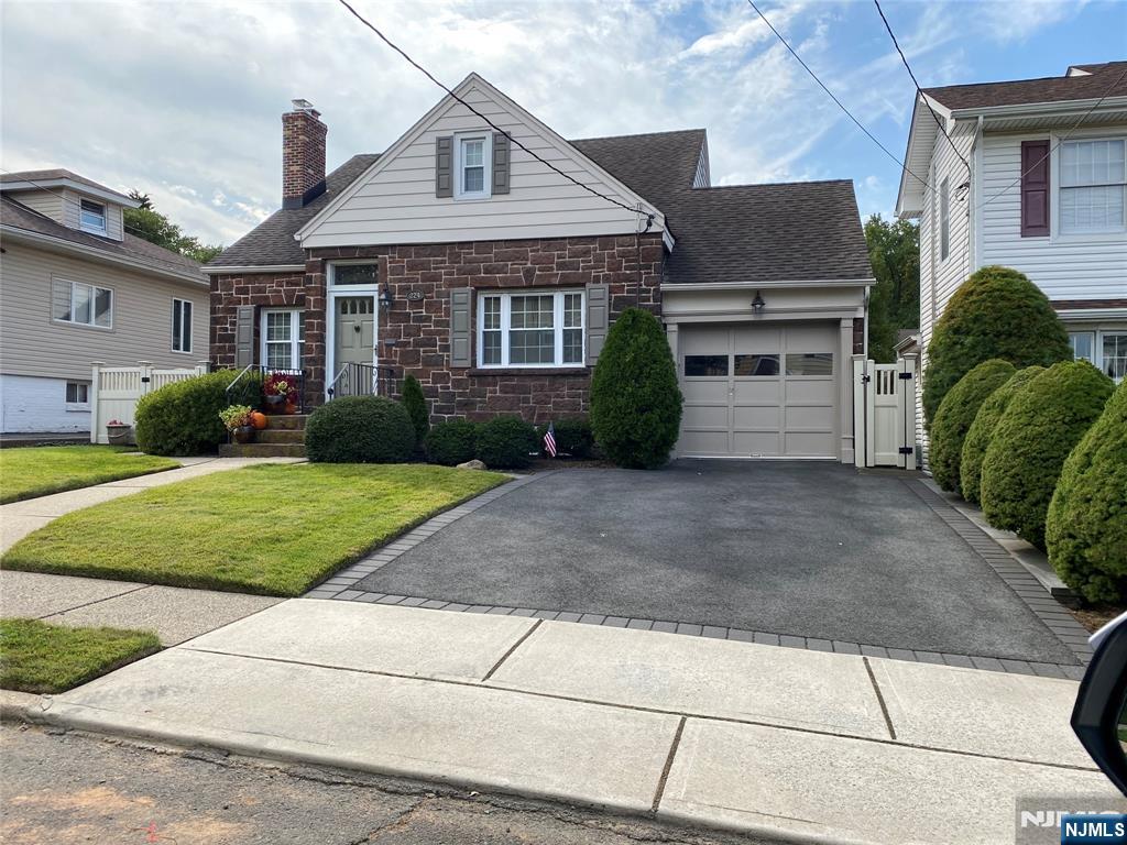 224 Cleveland Avenue Hasbrouck Heights, NJ 07604 - Photo 1 of 29 a front view of a house with a yard and garage