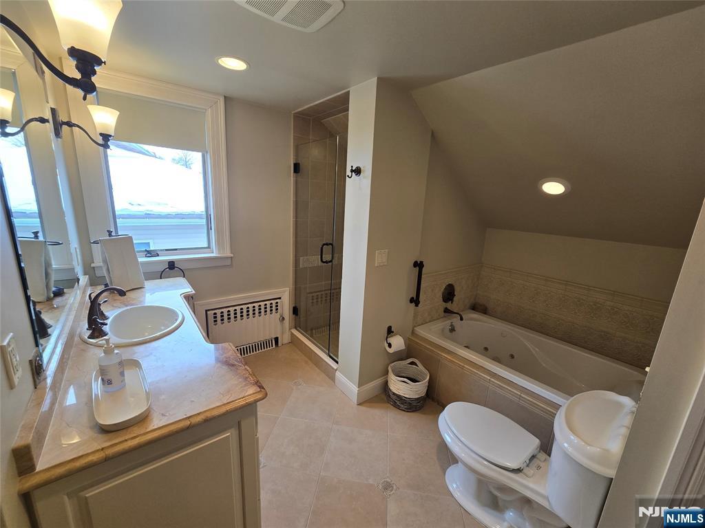 224 Cleveland Avenue Hasbrouck Heights, NJ 07604 - Photo 15 of 29 a bathroom with a sink toilet a mirror and tub