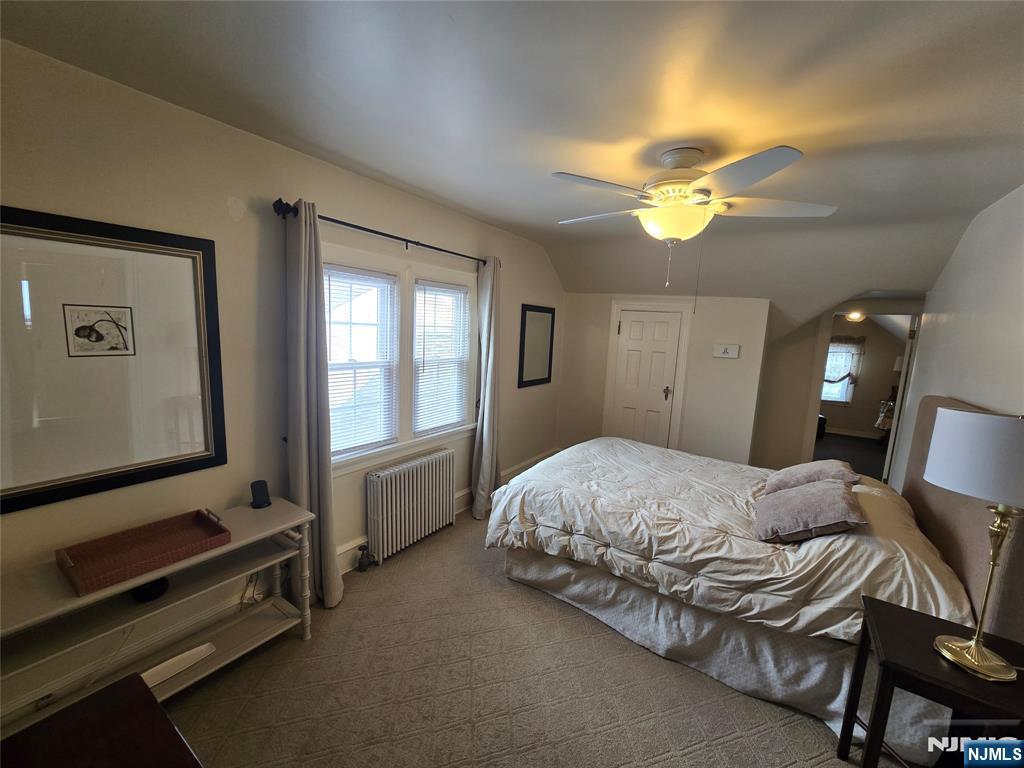 224 Cleveland Avenue Hasbrouck Heights, NJ 07604 - Photo 18 of 29 a spacious bedroom with a bed and a chandelier