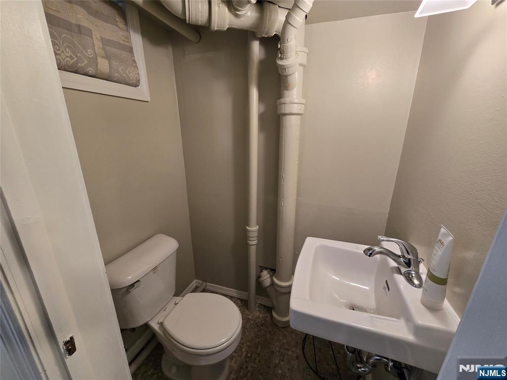 224 Cleveland Avenue Hasbrouck Heights, NJ 07604 - Photo 25 of 29 a white toilet sitting next to a bathroom sink