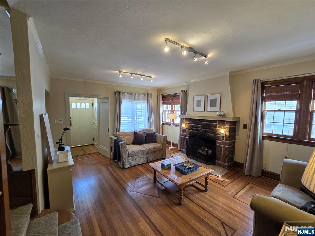 224 Cleveland Avenue Hasbrouck Heights, NJ 07604 - Photo 5 of 29 a living room with furniture flat screen tv and a fireplace