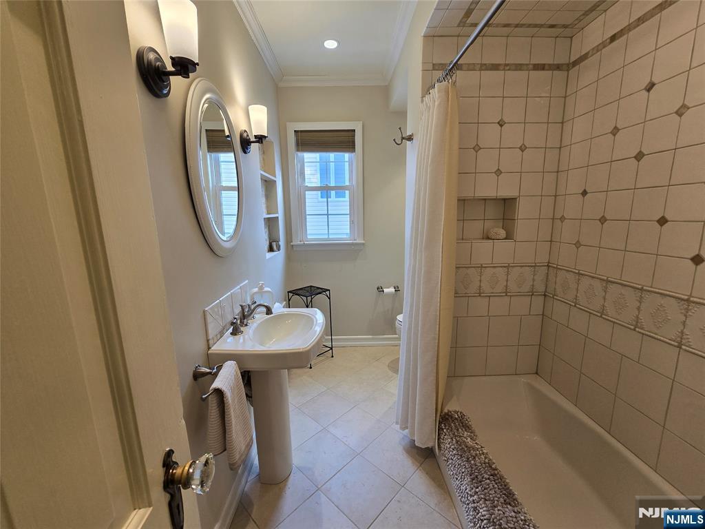 224 Cleveland Avenue Hasbrouck Heights, NJ 07604 - Photo 7 of 29 a bathroom with a sink a toilet and shower