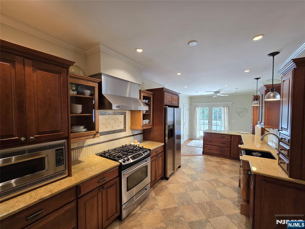 224 Cleveland Avenue Hasbrouck Heights, NJ 07604 - Photo 10 of 29 a kitchen with stainless steel appliances kitchen island granite countertop a stove and a refrigerator