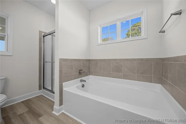 a white bath tub sitting next to a small bathroom
