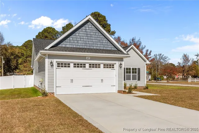 a view of a house with a yard and potted plants