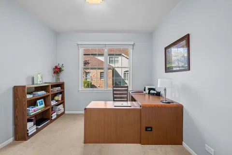 a room with furniture a baby crib and a window