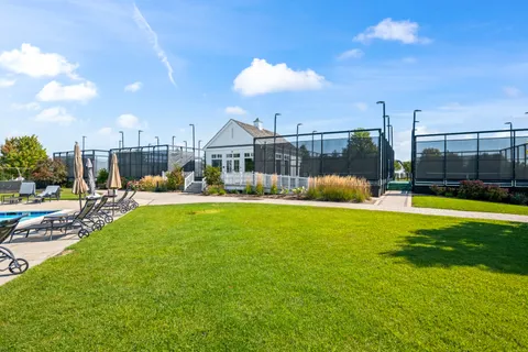 a view of a fountain in front of a house with a fountain