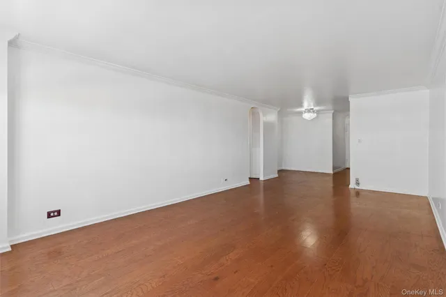 a view of an empty room and wooden floor