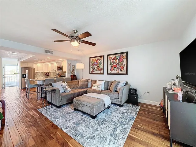 a living room with furniture a fireplace and a rug