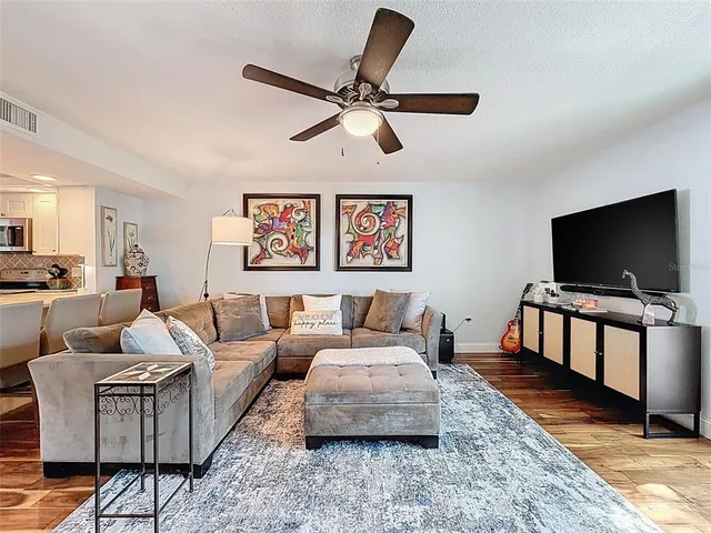 a view of living room with furniture and wooden floor