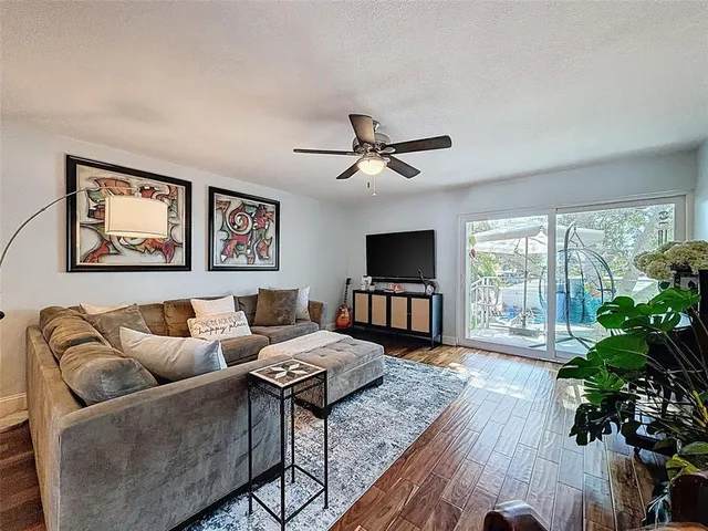 a hallway with white cabinets and wooden floor