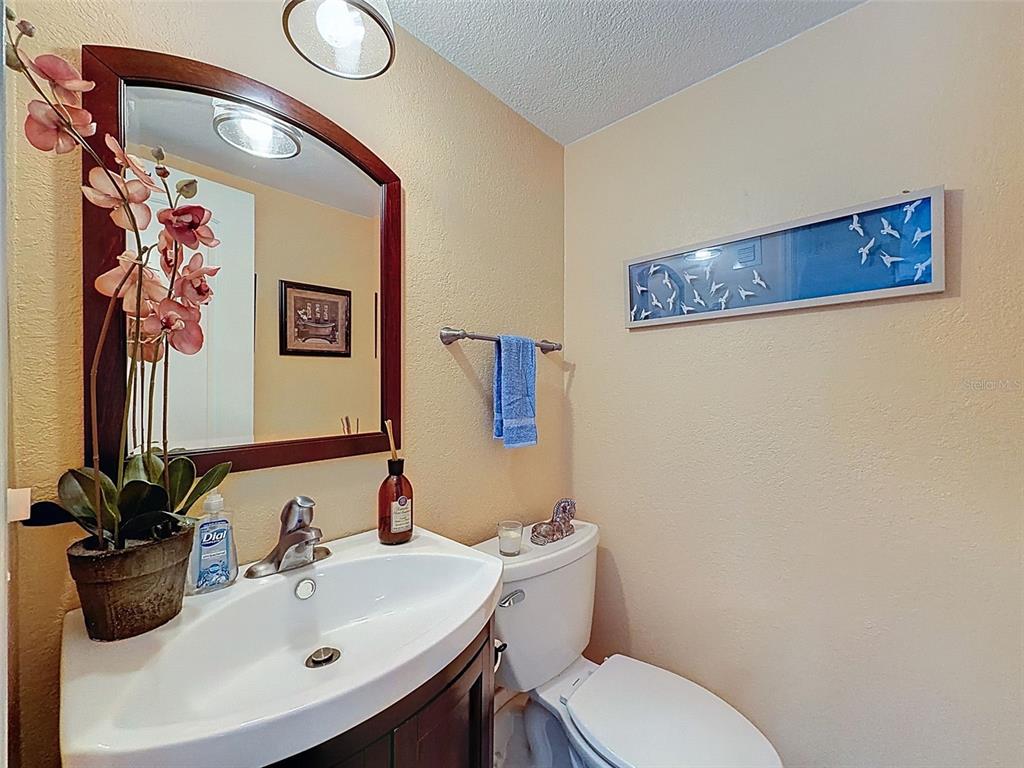 433 Paula Drive South, Unit 23 Dunedin, FL 34698 - Photo 24 of 56 a bathroom with a toilet sink and mirror