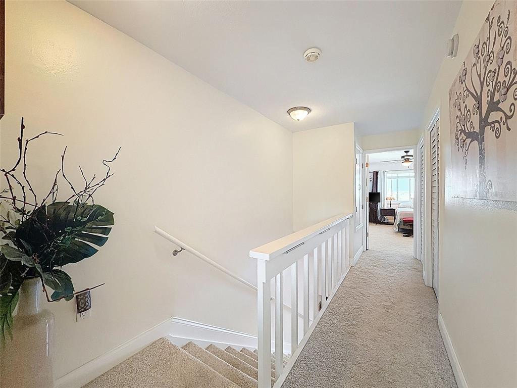 433 Paula Drive South, Unit 23 Dunedin, FL 34698 - Photo 26 of 56 a view of a hallway to a room with wooden floor