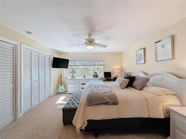 a bathroom with a granite countertop sink mirror and toilet