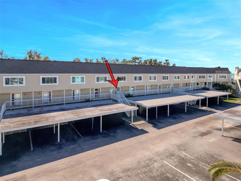 433 Paula Drive South, Unit 23 Dunedin, FL 34698 - Photo 3 of 56 a roof deck with a table and chairs